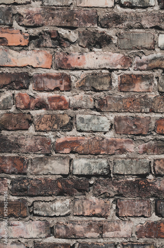 Faded old red brick wall  wide rough vintage panoramic texture. Dirty wall with grunge rectangular blocks  close-up  grungy texture of blackened bricks