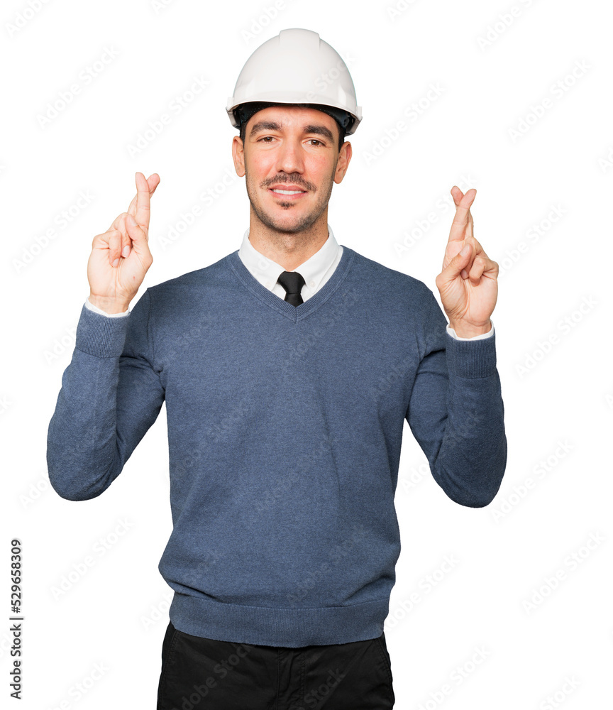 Young architect making a fingers crossed gesture