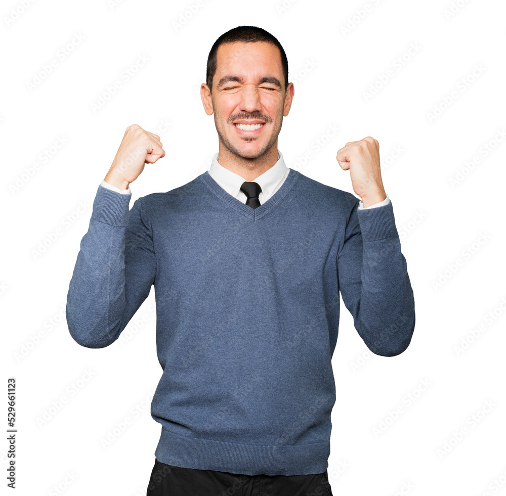 Competitive young man making a gesture of celebration Competitive young man making a gesture of celebration