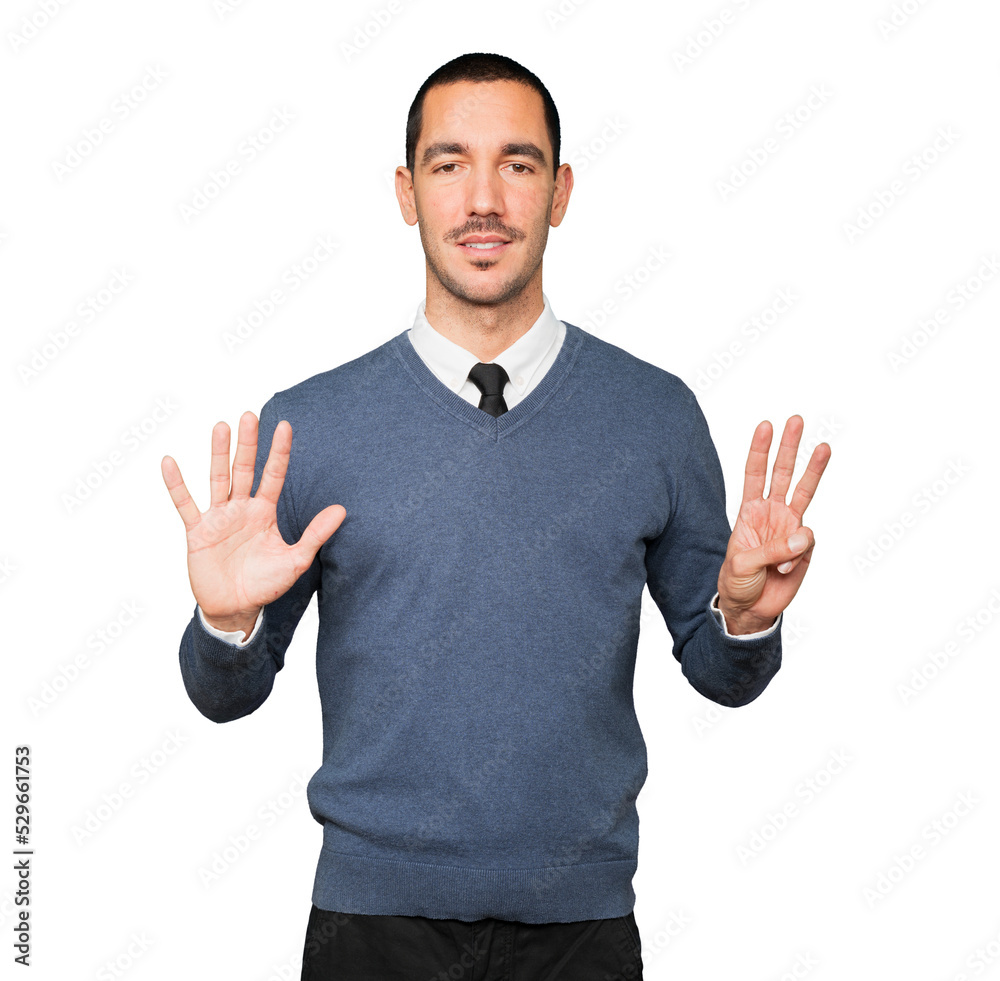 Happy young man doing a number eight gesture with his hands Happy young man doing a number eight gesture with his hands