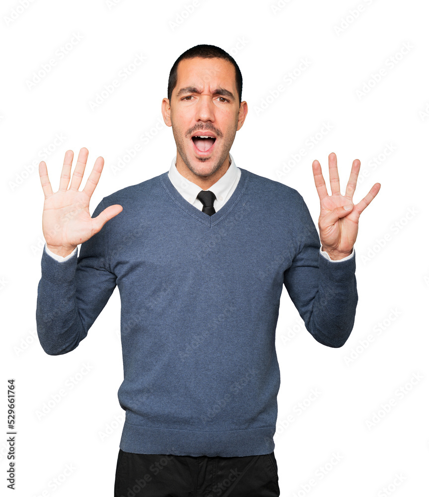 Happy young man doing a number nine gesture with his hands Happy young man doing a number nine gesture with his hands