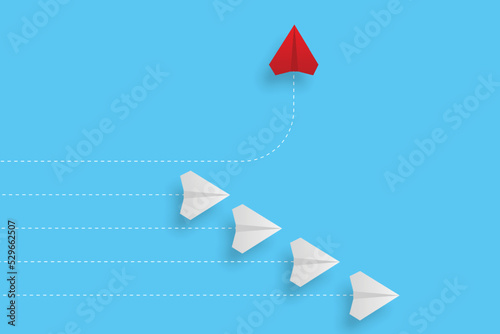 Creative paper planes on blue background. Think differently concept. Red airplane changing direction. New idea, change, trend, courage, creative solution, innovation and unique concept.