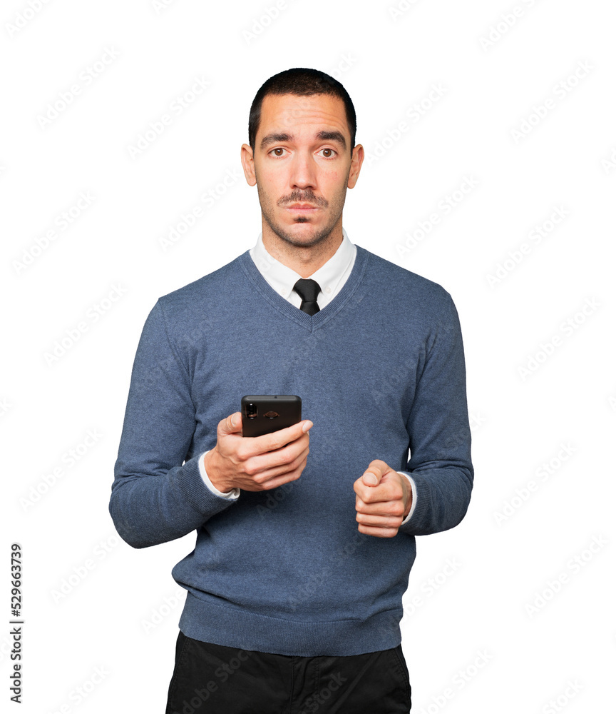 Sad young man using a mobile phone Sad young man using a mobile phone
