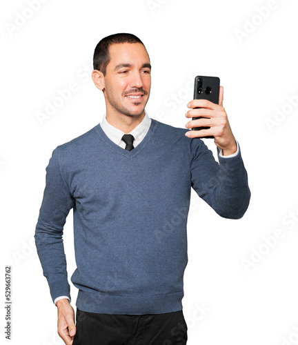 Happy young man taking a selfie with his mobile phone © agongallud
