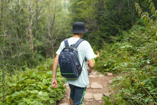 Young Man Traveler with backpack relaxing outdoor hiking traveling in forests. Poland landscape Travel Lifestyle success motivation concept adventure active vacations.