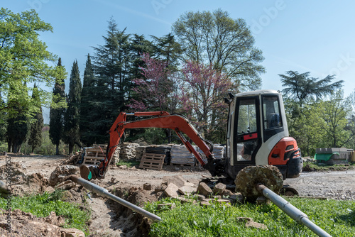 Wallpaper Mural A small excavator in the park that prepares the asphalt pitch. Torontodigital.ca