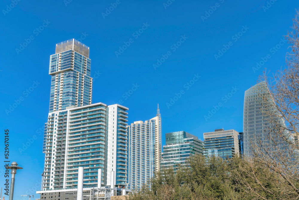 Facade of modern luxury apartments against blue sky background on a sunny day Facade of modern luxury apartments against blue sky background on a sunny day