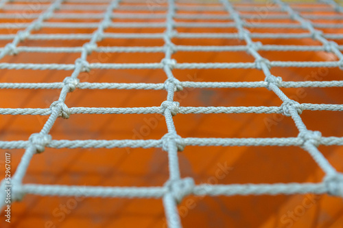 a net of thin ropes on the playground, close-up. 