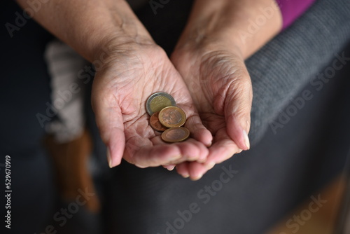Bills and coins on a woman's hand