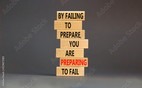 Preparing symbol. Concept words By failing to prepare you are preparing to fail on wooden blocks on a beautiful grey table grey background. Business motivational and preparing concept.