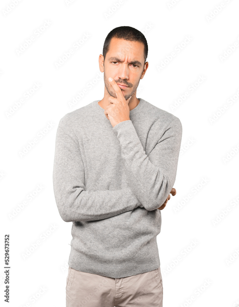 Concerned young man making a gesture of doubt Concerned young man making a gesture of doubt