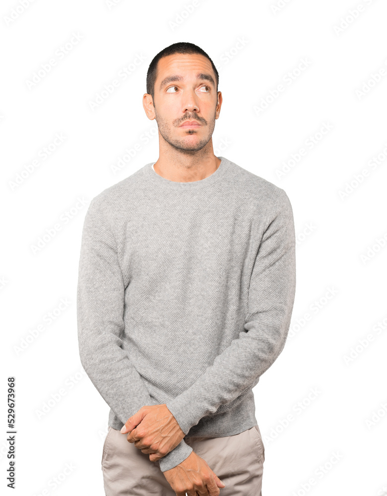 Serious young man looking against background