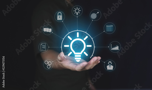 Business idea concept, people holding lightbulb icon with glowing virtual brain and connection line to creative smart thinking for inspiration and innovation with network concept. 
