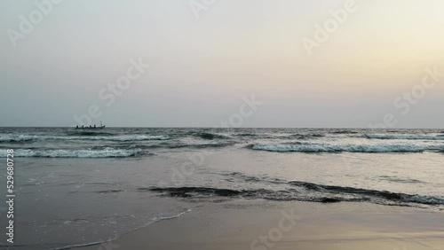Wallpaper Mural Beautiful view of waves rolling on sand at beach. Fishing boat in the ocean catching fish Torontodigital.ca