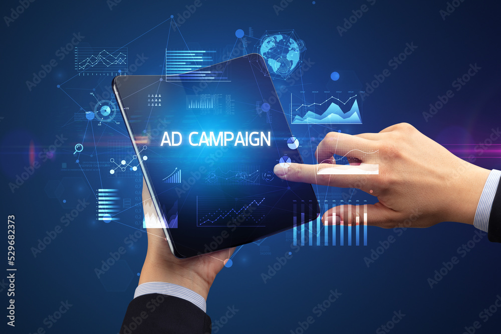 Businessman holding a foldable smartphone, business concept Businessman holding a foldable smartphone, business concept