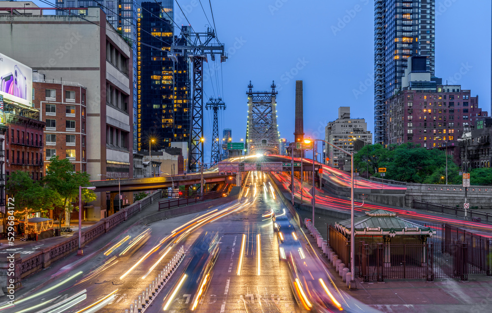 Queensborough bridge New York City Traffic at night light trails blue sky 