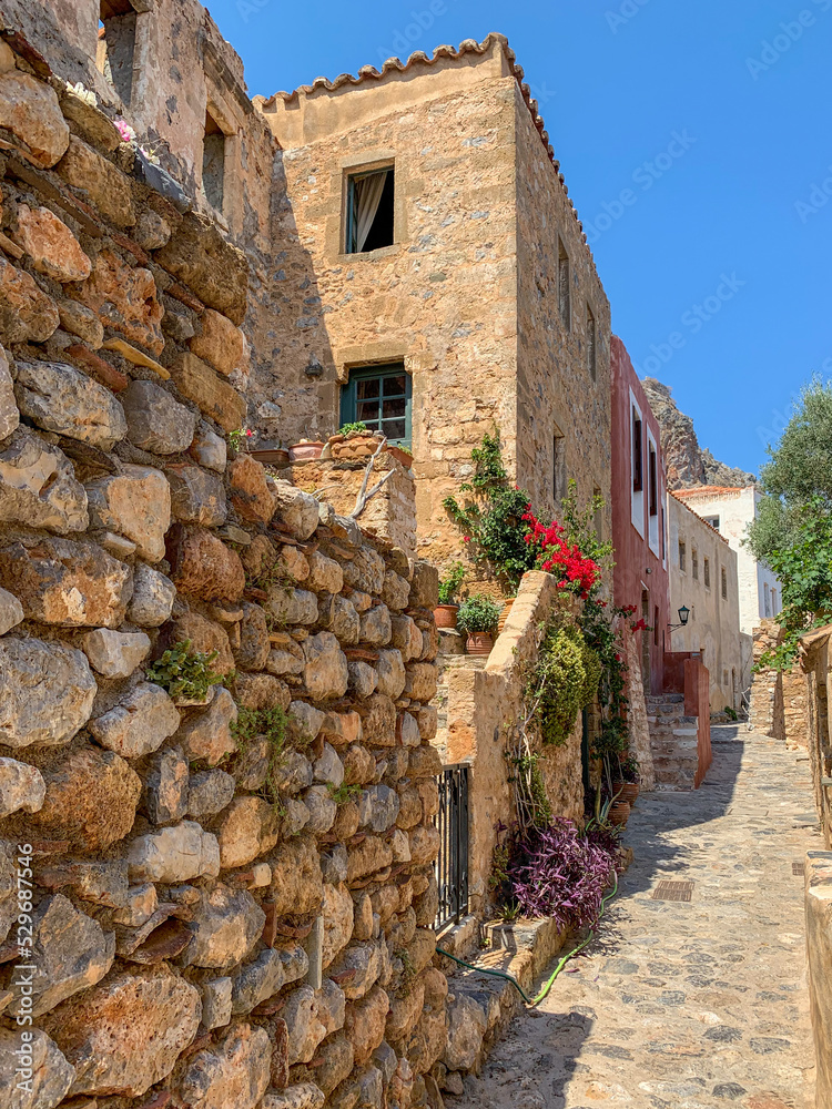 Street scene with building and stone wall in Monemvasia, Greece