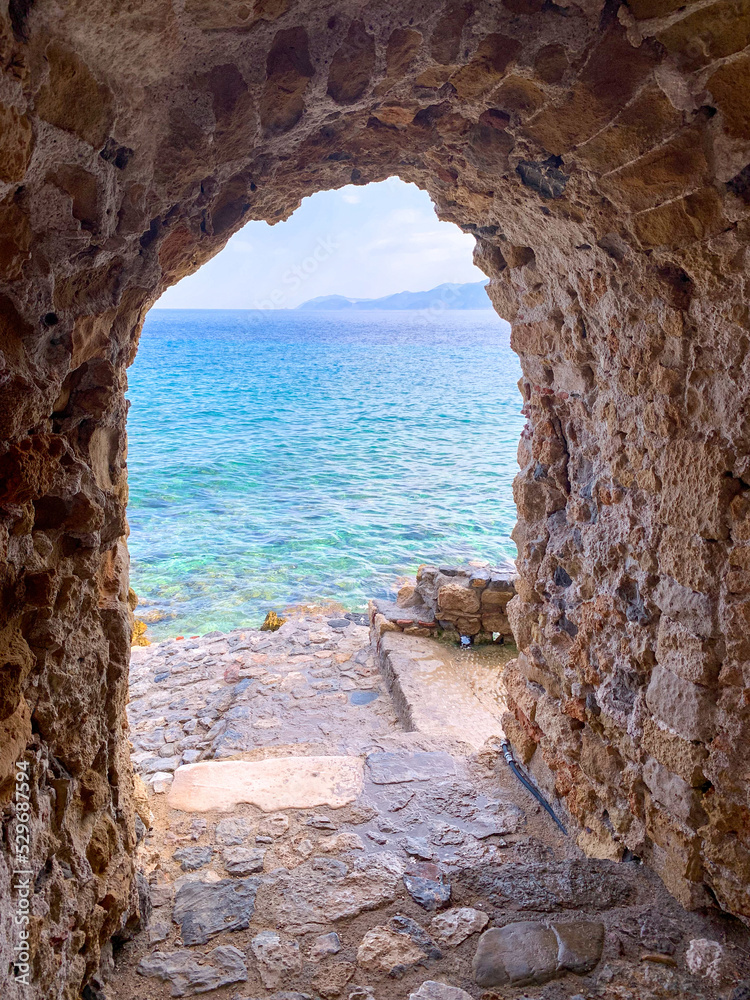 Blue sea through arch in Monemvasia, Greece