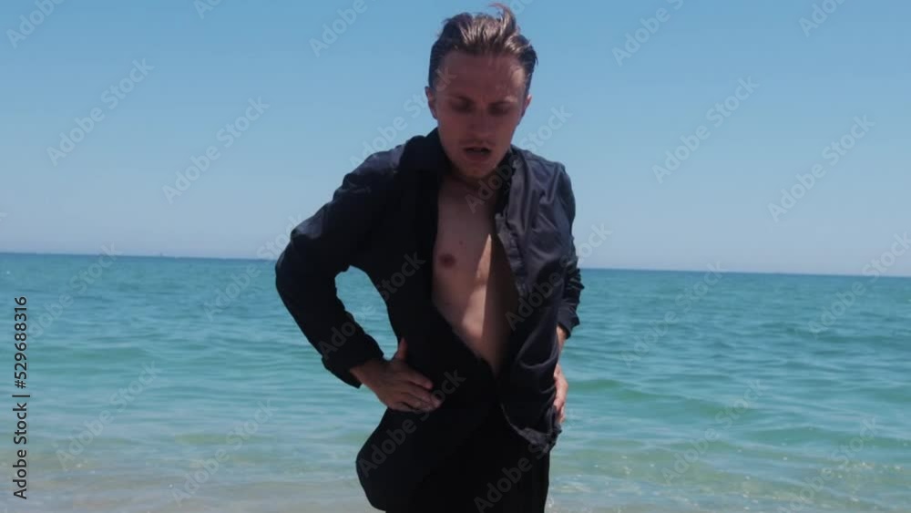 Graceful attractive man dancing on the seashore Graceful attractive man dancing on the seashore