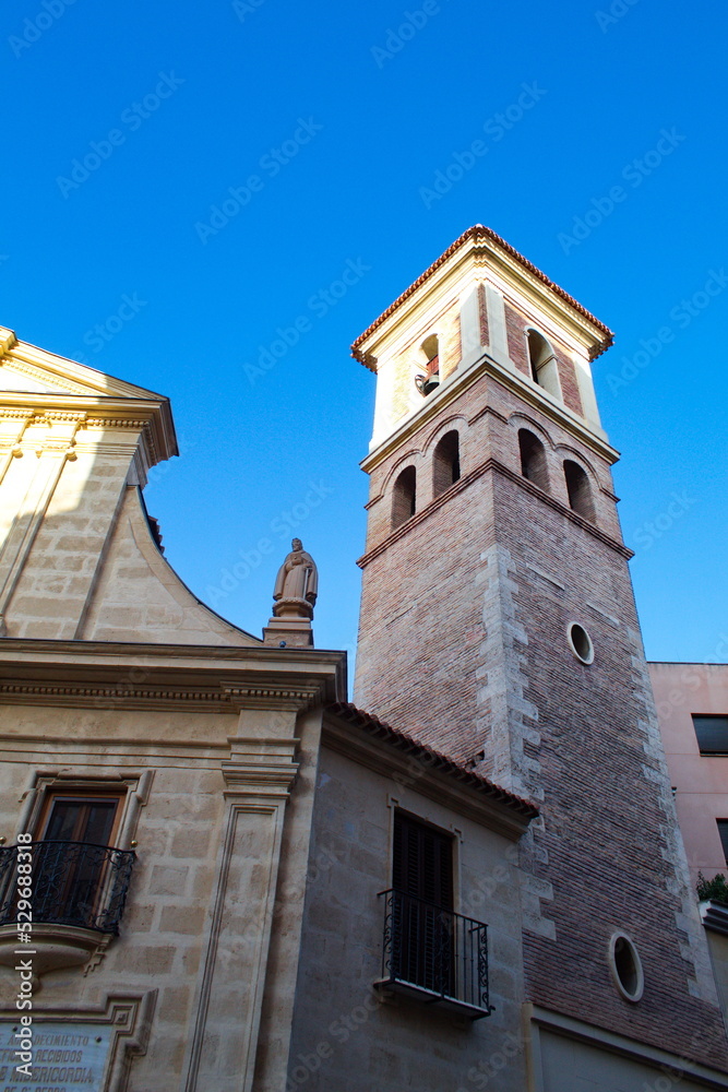 Nice facade with tower and bell tower of the church of Saint Peter in Murcia