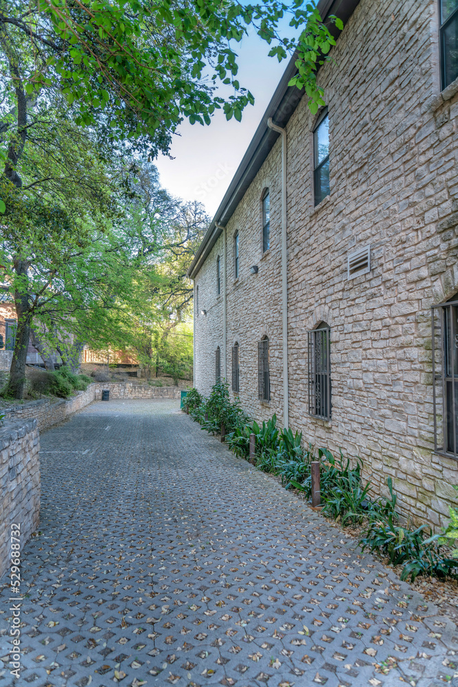 Scenic street in Austin Texas with pathway along building with stone brick wall
