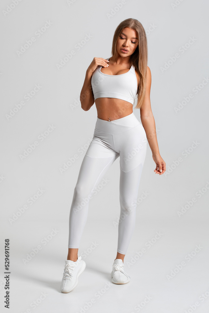 Fitness woman. Athletic girl on the gray background Fitness woman. Athletic girl on the gray background