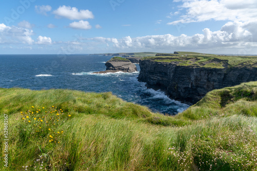 landscape view of the rugged coast and cliffs at the Cliffs of Kilkee in County Clare