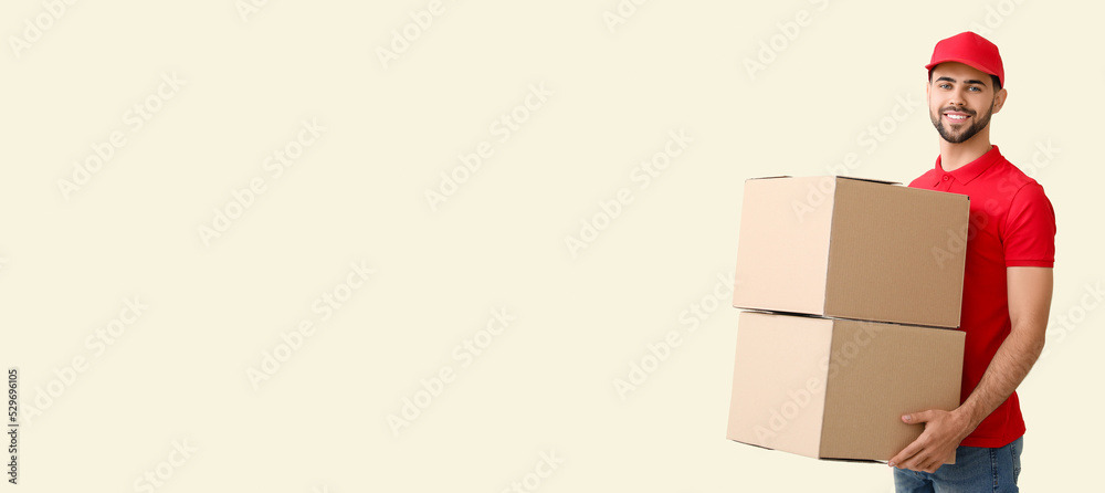 Delivery man holding parcels on light background with space for text Delivery man holding parcels on light background with space for text