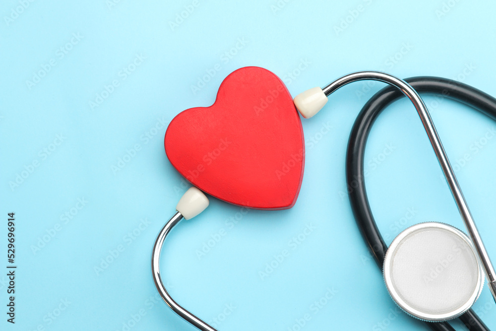 Stethoscope and red heart on a blue background. top view and free space. Cardiology and treatment of heart diseases. Stethoscope and red heart on a blue background. top view and free space. Cardiology and treatment of heart diseases.