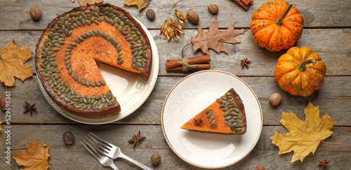 Composition with delicious pumpkin pie on wooden background, top view