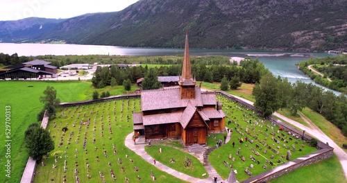 Wooden church in Lom stavkyrkje church in Norway Europe aerial rotation view in HDR photo