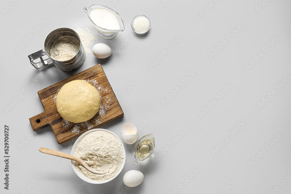 Set of ingredients for baking with raw dough on white background Set of ingredients for baking with raw dough on white background