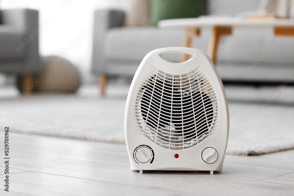 Electric fan heater on floor in living room Electric fan heater on floor in living room
