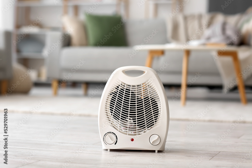 Electric fan heater on floor in living room Electric fan heater on floor in living room