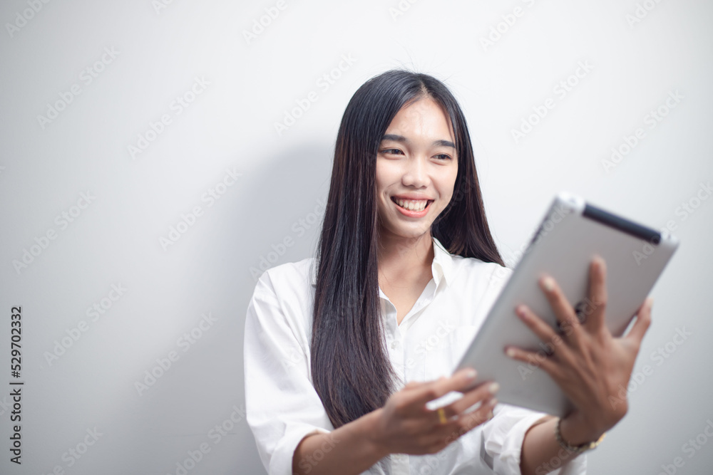 businesswoman working at home using tablet surf the internet Play social media in video meetings with colleagues. businesswoman working at home using tablet surf the internet Play social media in video meetings with colleagues.