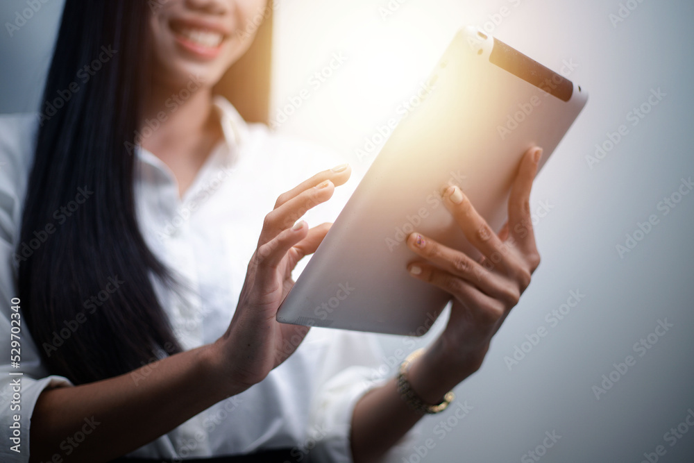 businesswoman working at home using tablet surf the internet Play social media in video meetings with colleagues. businesswoman working at home using tablet surf the internet Play social media in video meetings with colleagues.