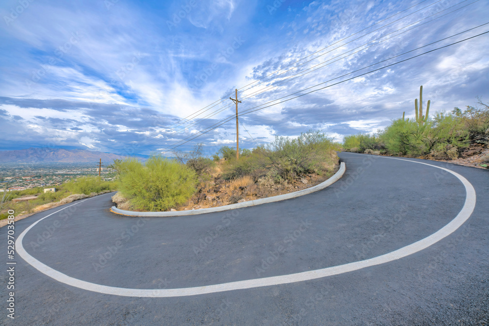 Downhill asphalt u-shaped bike path and walking pathway on a slope at Tucson, Arizona