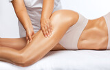 Masseur makes anti-cellulite massage on the legs, thighs, hips and buttocks in the spa. Overweight treatment, body sculpting.Cosmetology and massage concept.