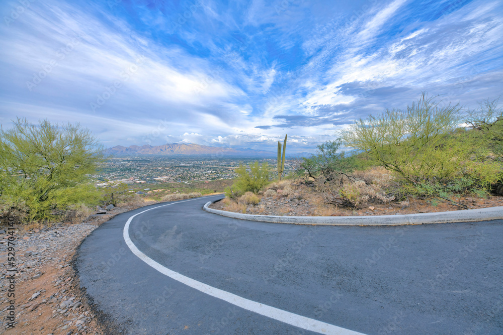 Downhill bike and walkway pathway with a view of Tucson, Arizona landscape below