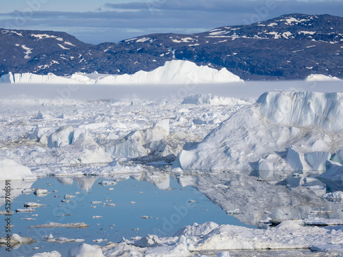 Awe-inspiring icy landscapes at the mouth of the Icefjord glacier (Sermeq Kujalleq), one of the fastest and most active glaciers in the world. A UNESCO world heritage site, Ilulissat, Greenland 