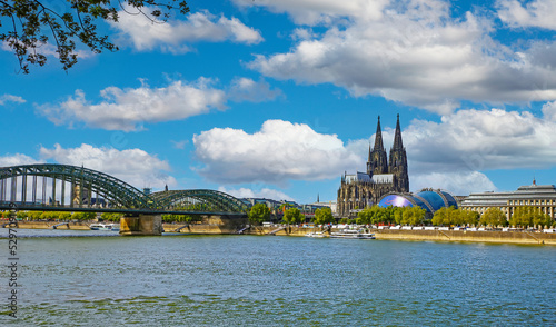 Cologne, Germany - July 9. 2022: View over river rhine on gothic dom towers, Hhohenzollern bridge, musical dome in summer