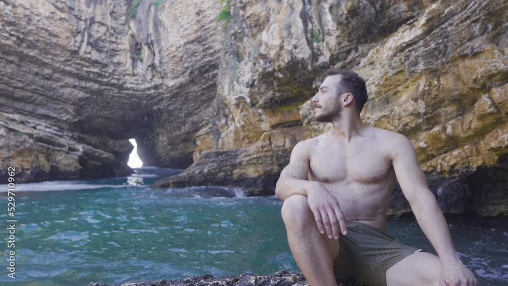 Young man on the shore of the wavy sea.
The young man sitting on the cliffs by the sea watches his surroundings.
Young man on the shore of the wavy sea.
The young man sitting on the cliffs by the sea watches his surroundings.