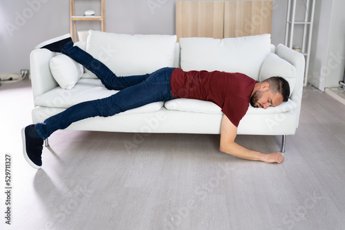 Man With Lethargy And Fatigue On Couch