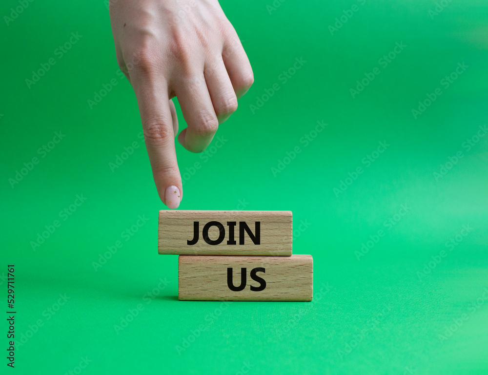 Join us symbol. Concept word Join us on wooden blocks. Beautiful green background. Businessman hand. Business and Join us concept. Copy space Join us symbol. Concept word Join us on wooden blocks. Beautiful green background. Businessman hand. Business and Join us concept. Copy space
