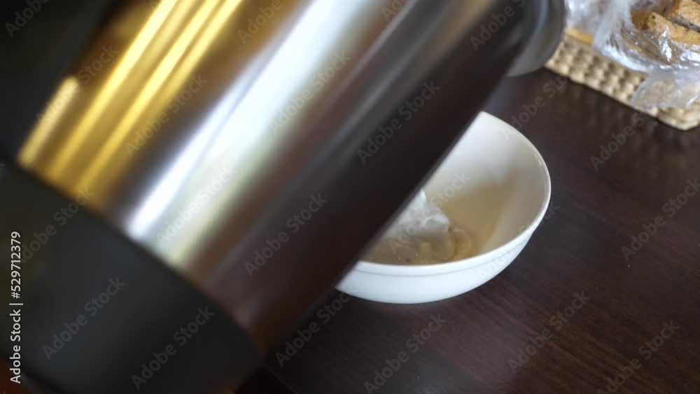 Pouring freshly made semolina into a ceramic bowl