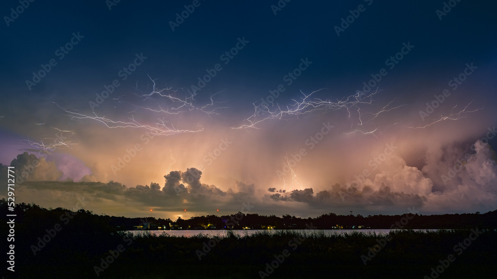 Fototapeta premium Lightning storm reflected in lake