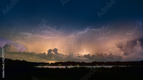 Lightning storm reflected in lake