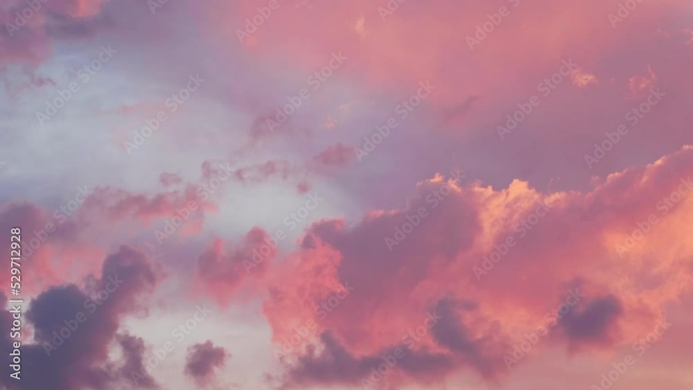 Cloudy sky with moving evening gold orange pink clouds. Beautiful Sunset or Sunrise. Natural background dramatic sky. Amazing light of nature cloudscape sky. Relax Timelapse Time-Lapse Time lapse 