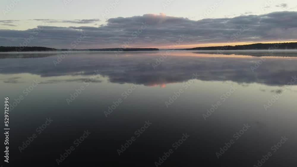 Flying over foggy lake early morning at sunrise. Drone video. Flying over foggy lake early morning at sunrise. Drone video.
