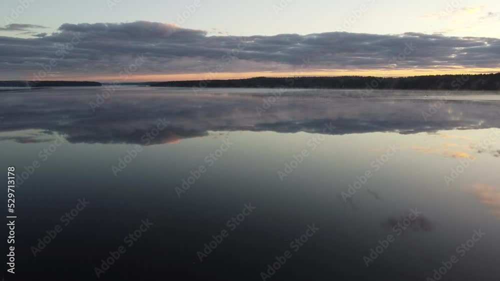 Flying over foggy lake early morning at sunrise. Drone video. Flying over foggy lake early morning at sunrise. Drone video.